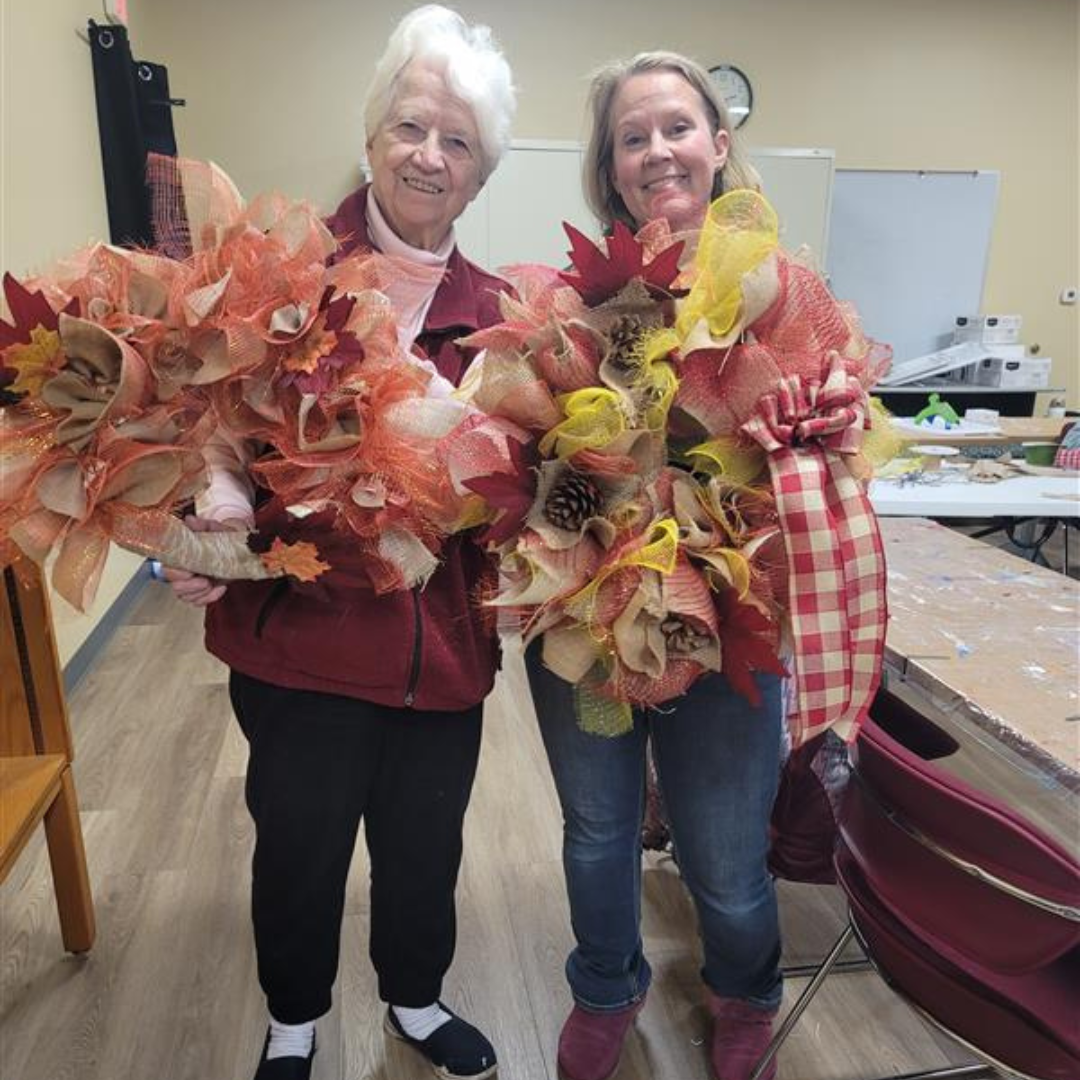 Image of 2 Garden Club members and their fall wreaths