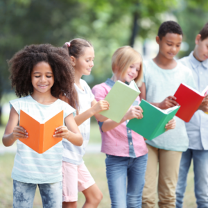 Children reading books outside